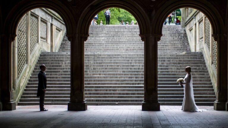 A bride and groom pose for wedding pictures at the Bethesda Terrace in New York's Central Park on May 23, 2017. (AP Photo/Mary Altaffer, File)