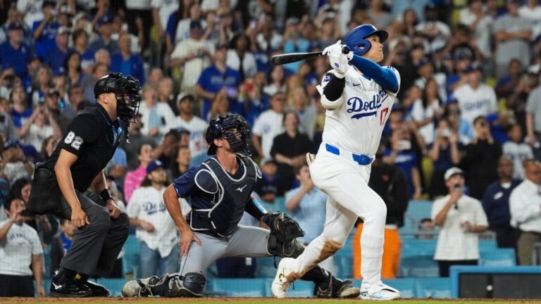 Los Angeles Dodgers designated hitter Shohei Ohtani (17) hits a grand slam during the ninth inning of a baseball game against the Tampa Bay Rays in Los Angeles, Aug. 23, 2024. (AP Photo/Ashley Landis)