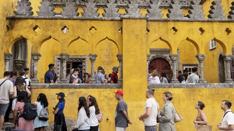 Tourists queue to visit the interior of the 19th century Pena Palace in Sintra, Portugal, Wednesday, Aug. 14, 2024. (AP Photo/Ana Brigida)