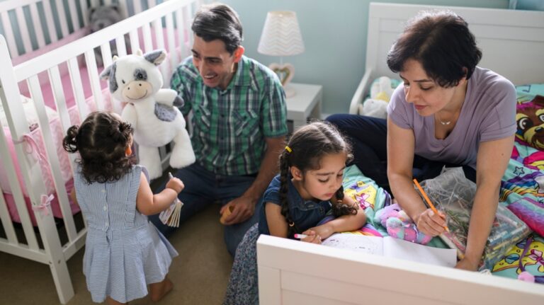 Hamid Ahmadpanah, left, and his wife Shohreh Aghababaei spend time with their children at their home in Ottawa on June 8, 2023. (Justin Tang / The Canadian Press)