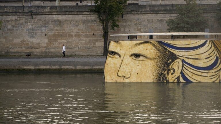 Reproductions of artworks decorate the banks of the River Seine at the 2024 Summer Olympics, Tuesday, July 30, 2024, in Paris, France. (AP Photo/ Dar Yasin, File)