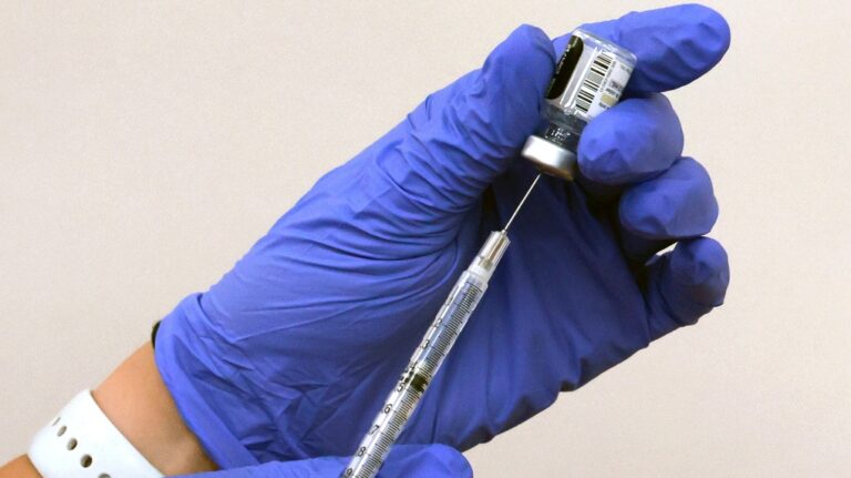 ACVS pharmacist prepares to administer a shot of Comirnaty, the new Pfizer/BioNTech vaccination booster for COVID-19. (Joe Burbank/Orlando Sentinel via AP)