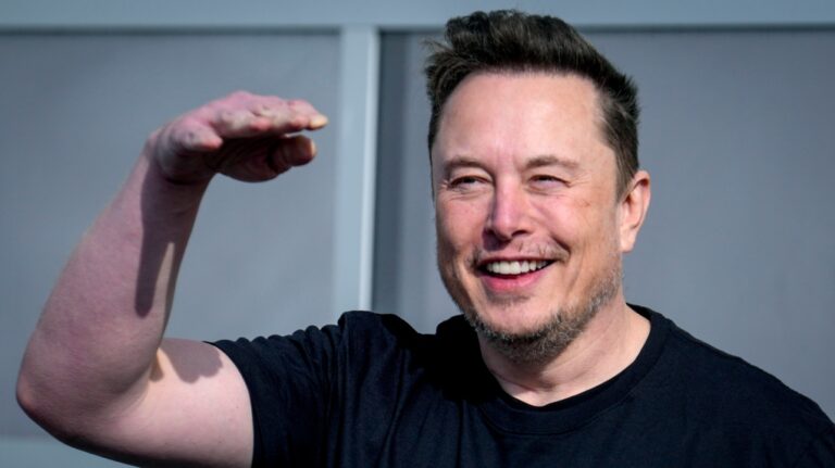 Tesla CEO Elon Musk waves as he leaves the Tesla Gigafactory for electric cars after a visit in Gruenheide near Berlin, Germany, Wednesday, March 13, 2024. (AP Photo/Ebrahim Noroozi)