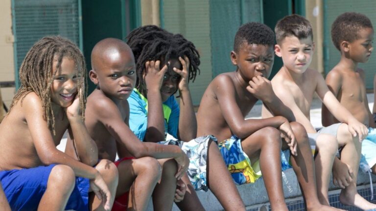 A group of boys look on during a swimming lesson, Thursday, June 18, 2015, in Miami. THE CANADIAN PRESS/AP/Wilfredo Lee