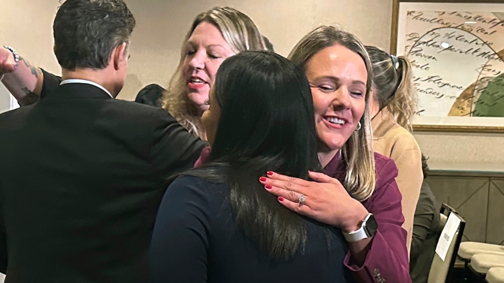 Attorney Kelly Fitzpatrick, right, hugs plaintiff Soryorelis Henry, foreground right, after a news conference in New Haven, CT, Monday, Sept. 9, 2024. (Dave Collins / AP Photo)
