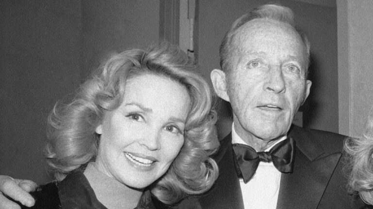 Bing Crosby stands with his wife, Kathryn, left in New York on Dec. 8, 1976. (AP Photo/Carlos Rene Perez, File)