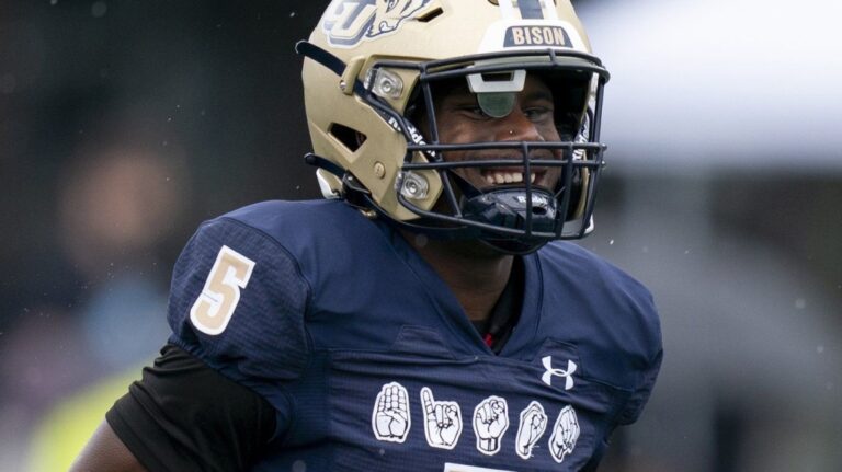 Gallaudet quarterback Brandon Washington runs wearing a football helmet that helps deaf and hard-of-hearing players see play calls on a lens inside during an NCAA college football game against Hilbert College, Oct. 7, 2023, in Washington. (AP Photo/Stephanie Scarbrough, File)