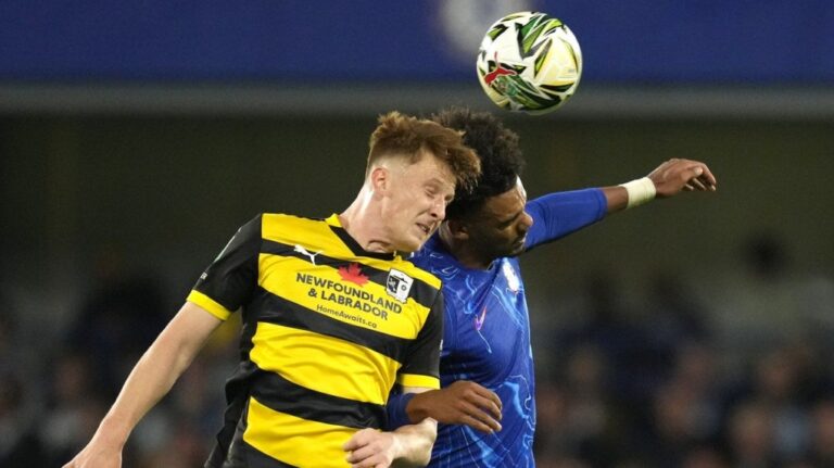Barrow's Ged Garner, left, challenges for the ball with Chelsea's Renato Veiga during an FA Cup match between Chelsea and Barrow at Stamford Bridge stadium in London, Tuesday, Sept. 24, 2024.