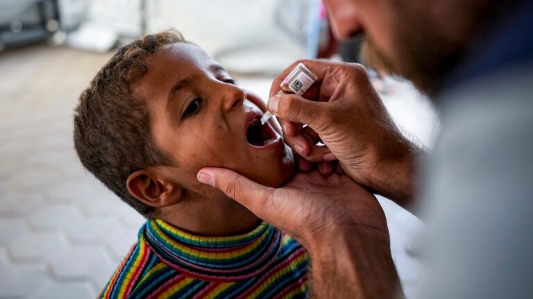 A health worker administers a polio vaccine to a child at a hospital in Deir al-Balah, central Gaza Strip, Sunday, Sept. 1, 2024. (Abdel Kareem Hana / AP Photo)