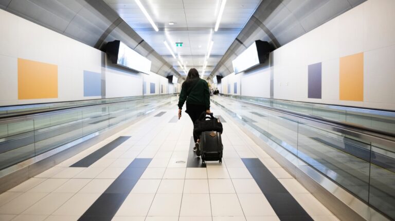 People walk through Billy Bishop Airport in Toronto on Friday, July 19, 2024. (Christopher Katsarov / The Canadian Press)