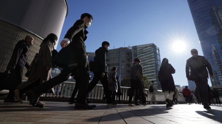 Commuters walk in a passageway during a rush hour at Shinagawa Station, Feb. 14, 2024, in Tokyo. (AP Photo/Eugene Hoshiko, File)