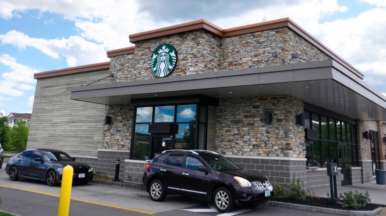 Cars drive through the pick-up window at a Starbucks store, Wednesday, May 29, 2024, in Salem, N.H. (Charles Krupa / AP Photo, Pool)