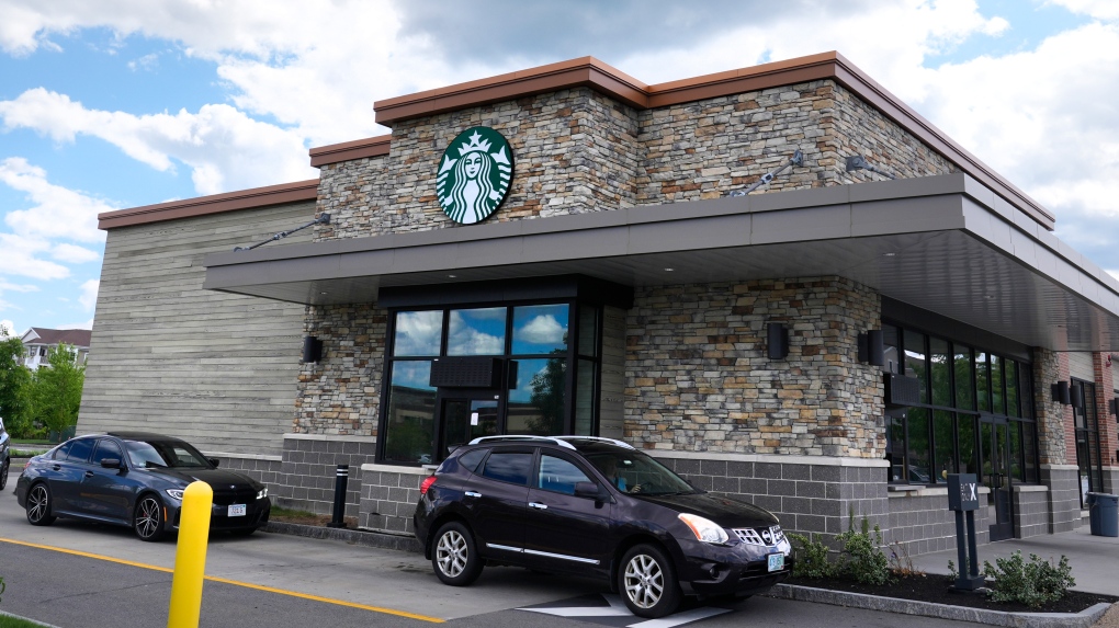 Cars drive through the pick-up window at a Starbucks store, Wednesday, May 29, 2024, in Salem, N.H. (Charles Krupa / AP Photo, Pool)
