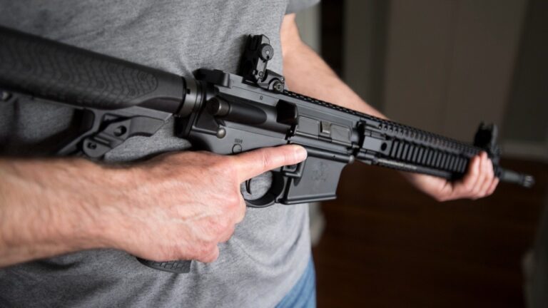 A restricted gun licence holder holds an AR-15 at his home in Langley, B.C., on May 1, 2020. THE CANADIAN PRESS/Jonathan Hayward