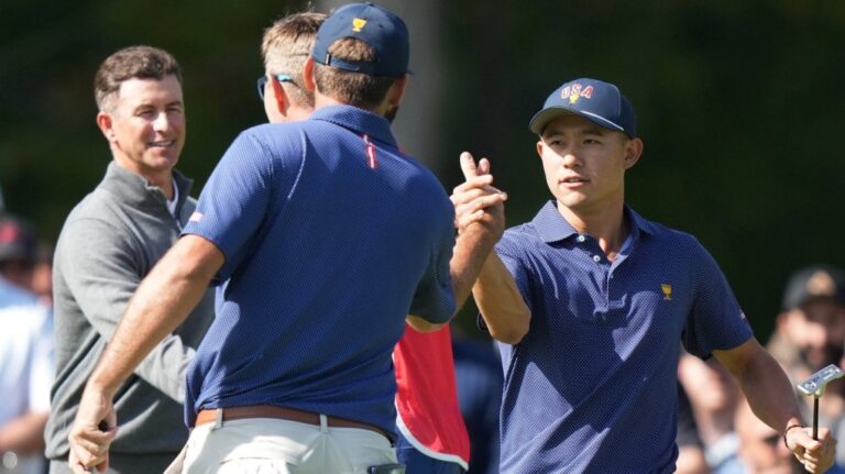 Collin Morikawa shakes hands with Scottie Scheffler after winning their third-round four-ball match at the 2024 Presidents Cup golf tournament. (Nathan Denette/The Canadian Press)