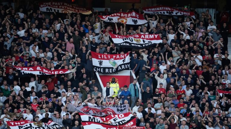Manchester United fans react ahead of the English Premier League soccer match between Manchester United and Fulham at Old Trafford, Friday, Aug. 16, 2024, in Manchester, England. (AP Photo/Dave Thompson)