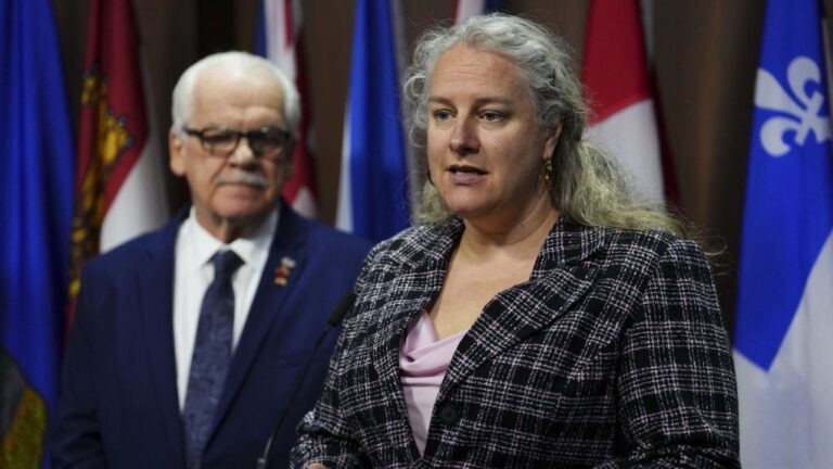 Jennifer Carr, PIPSC President, speaks as Chris Aylward, PSAC National President looks on during a press conference on Parliament Hill in Ottawa on Tuesday, Feb. 27, 2024., On Monday, federal public servants will return to the office a minimum of three days a week. THE CANADIAN PRESS/Sean Kilpatrick