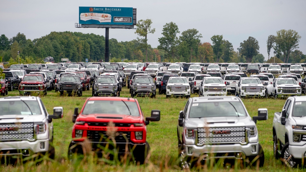 The Chevrolet Silverados and GMC Sierra pickups built at Flint Assembly are parked on Sept. 21, 2021. (Jake May/The Flint Journal via AP)