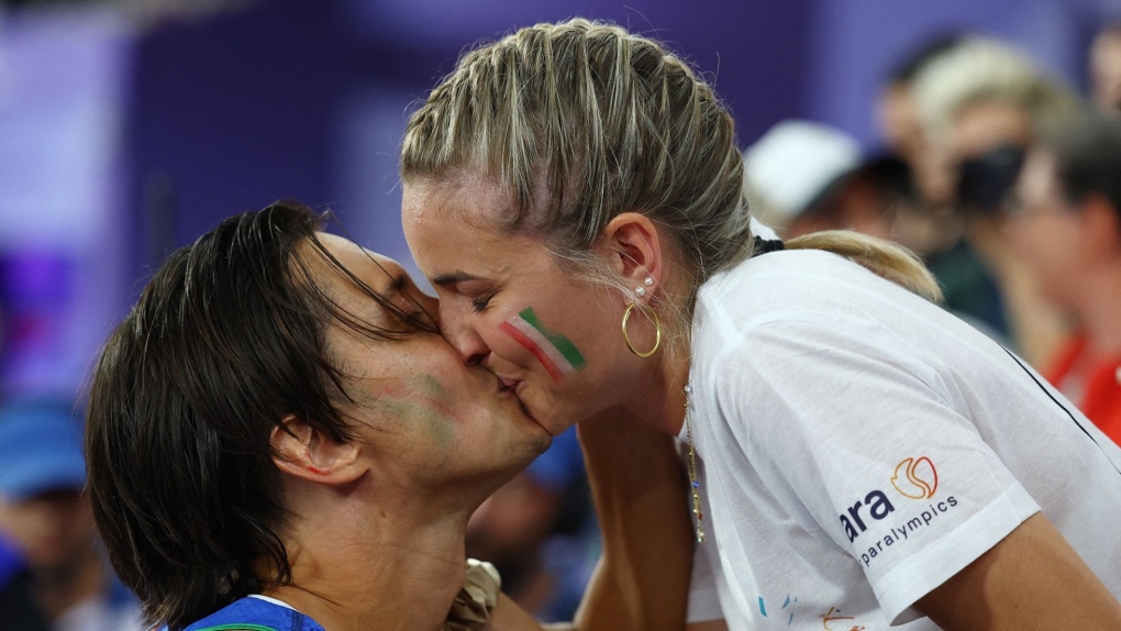 Alessandro Ossola's surprised girlfriend Ariana accepted his proposal at the Stade de France. (Eng Chin An/Reuters via CNN Newsource)