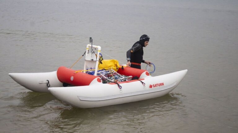 Jim Dreyer heads out into Lake Michigan in Grant Haven, Mich., Aug. 6, 2024, in his attempt to swim to Wisconsin. (Blace Carpenter/The Tribune via AP)