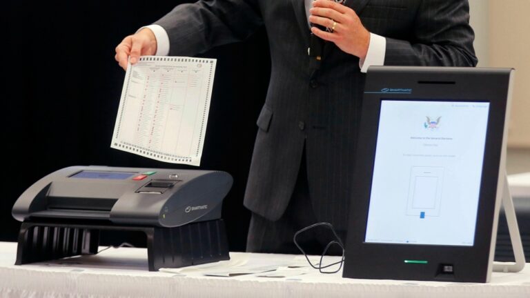 A Smartmatic representative demonstrates his company's system at a meeting of the Secure, Accessible & Fair Elections Commission, Aug. 30, 2018, in Grovetown, Ga. (Bob Andres/Atlanta Journal-Constitution via AP, File)