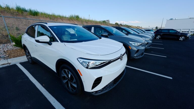 A long row of unsold 2024 electric ID4 utility vehicles is shown Sunday, July 28, 2024, at a Volkswagen dealership in Denver. (AP Photo/David Zalubowski)