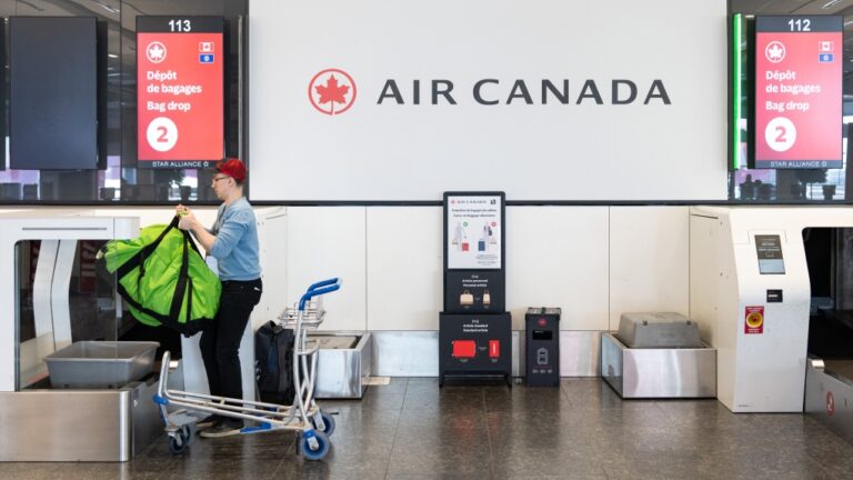 A traveller deposits his luggage at Montreal-Pierre Elliott Trudeau International Airport on Sept. 13, 2024. (Christinne Muschi / The Canadian Press)