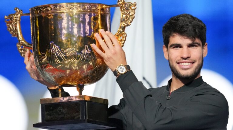 Carlos Alcaraz of Spain poses with his trophy after winning against Jannik Sinner of Italy during their men's singles finals match of the China Open tennis tournament, at the National Tennis Center in Beijing, Wednesday, Oct. 2, 2024. (Achmad Ibrahim / AP Photo)