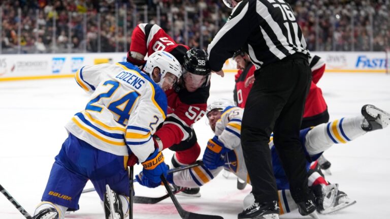 Buffalo Sabres' Dylan Cozen, left, faces off with New Jersey Devils' Erik Haula during the NHL hockey game between Buffalo Sabres and New Jersey Devils, in Prague, Czech Republic, Saturday, Oct. 5, 2024. (AP Photo/Petr David Josek)