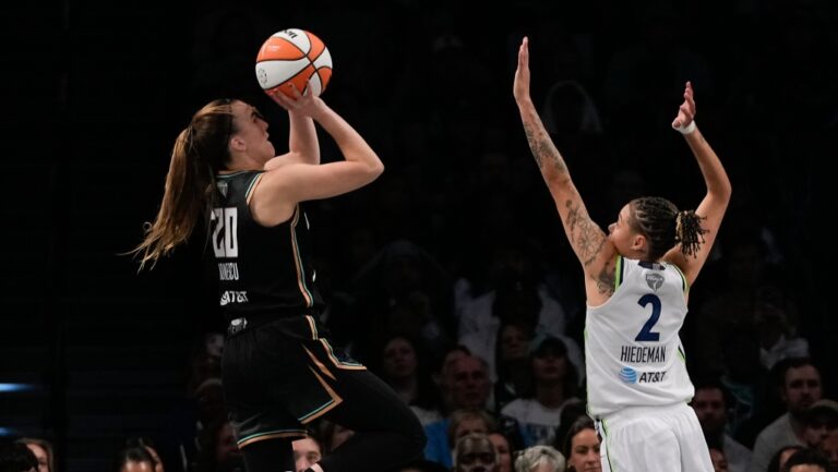 New York Liberty guard Sabrina Ionescu (20) puts up a shot against Minnesota Lynx guard Natisha Hiedeman (2) during the fourth quarter of Game 5 of the WNBA basketball final series, Sunday, Oct. 20, 2024, in New York. (Pamela Smith/AP Photo)