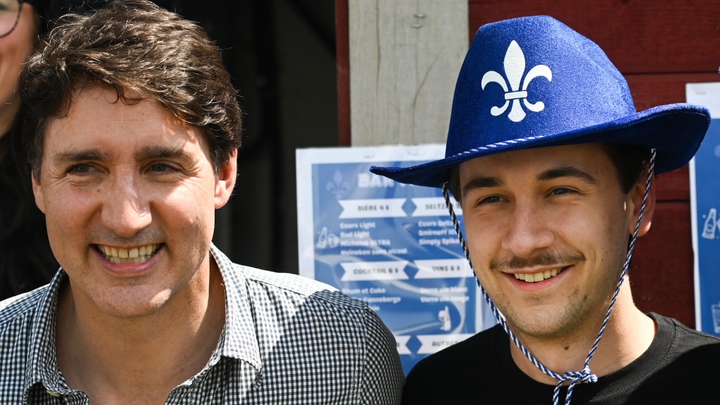Prime Minister Justin Trudeau poses with a man during a Fete Nationale event in Saint-Maurice, Que. on June 24, 2024 (THE CANADIAN PRESS/Graham Hughes)
