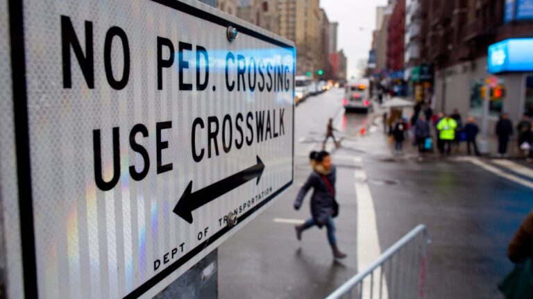 A pedestrian runs towards a crosswalk at the busy intersection of W. 96th Street and Broadway in the Upper West Side of New York Monday, Jan. 27, 2014. (AP Photo/Craig Ruttle)
