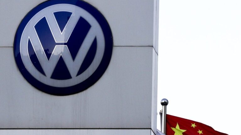 A Chinese national flag flutters near a Volkswagen logo in Beijing, Tuesday, April 18, 2017. (AP Photo/Andy Wong, File)