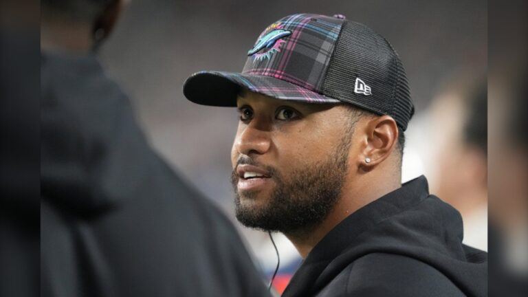 Miami Dolphins quarterback Tua Tagovailoa talks on the sidelines during the second half of an NFL football game against the Tennessee Titans, Monday, Sept. 30, 2024, in Miami Gardens, Fla. (AP Photo/Rebecca Blackwell)