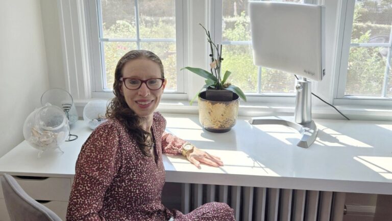 Miriam Cherry poses for a photo in her home where she uses a light therapy device to treat seasonal affective disorder, in Larchmont, New York, on Sept. 4, 2024. (Miriam Cherry via AP)