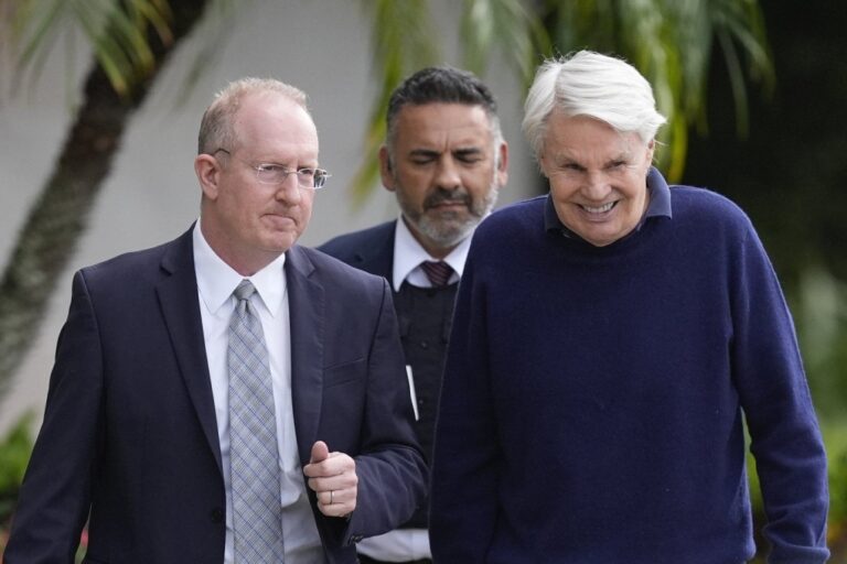 Michael Jeffries, right, former CEO of Abercrombie & Fitch, leaves with his attorney Brian Bieber, left, following a hearing at the Paul G. Rogers Federal Building and U.S. Courthouse, in West Palm Beach, Fla., Tuesday, Oct. 22, 2024. (AP Photo/Rebecca Blackwell)