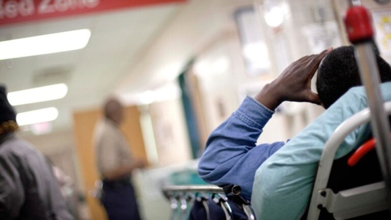 A patient waits along the wall of a hallway in a hospital emergency room in this 2011 photo. (AP / David Goldman)