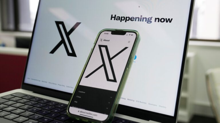 The opening page of X is displayed on a computer and phone in Sydney, Monday, Oct. 16, 2023. (AP Photo/Rick Rycroft)