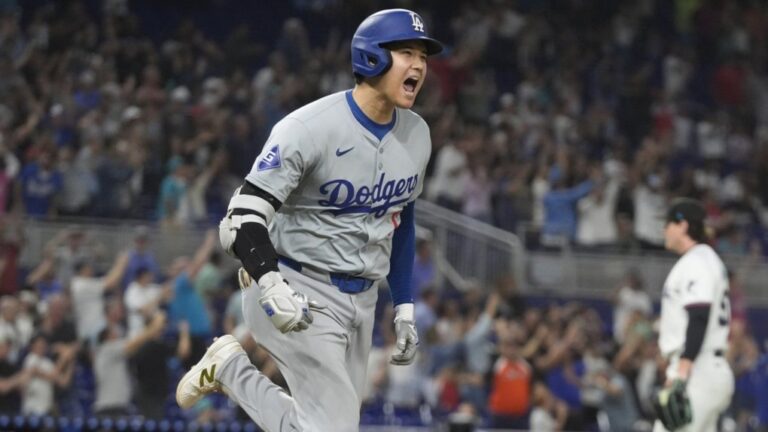 Los Angeles Dodgers' Shohei Ohtani reacts after hitting his 50th home run of the season during the seventh inning of a baseball game against the Miami Marlins, Sept. 19, 2024/ AP Photo/Marta Lavandier