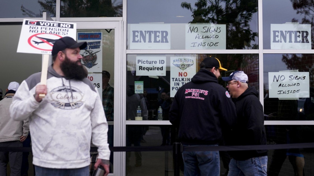 Boeing employees on strike enter a voting location to cast their ballots on a new contract offer from the company, Wednesday, Oct. 23, 2024, at the Angel of the Winds Arena in Everett, Wash. (AP Photo/Lindsey Wasson)