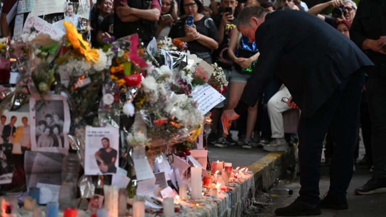 Geoff Payne, right, the father of former One Direction singer Liam Payne, visits a memorial outside the Casa Sur Hotel where the British pop singer fell to his death from a hotel balcony, in Buenos Aires, Argentina, Friday, Oct. 18, 2024. (AP Photo/Mario De Fina)