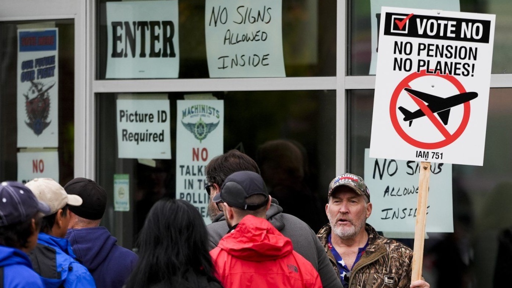 Bartley Stokes Sr., who has worked for Boeing for 46 years, encourages other employees on strike to vote no on a new contract offer from the company Wednesday, Oct. 23, 2024, at a voting location in the Angel of the Winds Arena in Everett, Wash. (AP Photo/Lindsey Wasson)