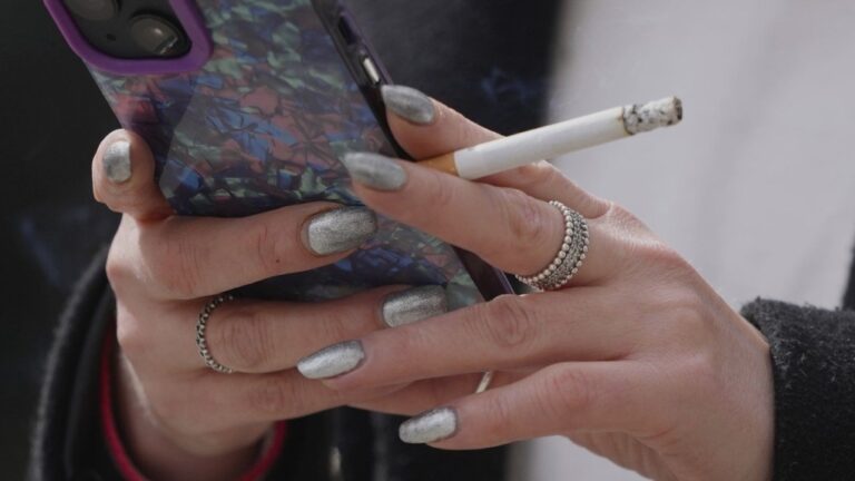 A woman smokes on a street, in London, Tuesday, April 16, 2024.  (AP, Kin Cheung)