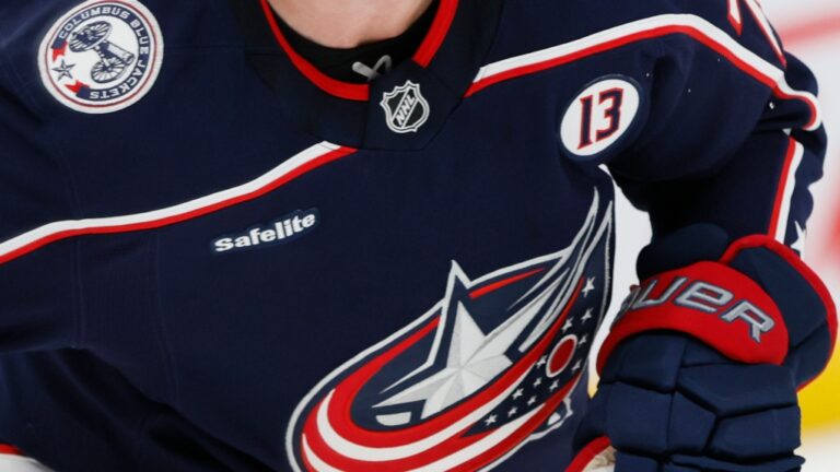 Columbus Blue Jackets players wear helmet stickers and patches honoring Johnny Gaudreau and his brother Matthew during the first period of an NHL hockey game against the Florida Panthers Tuesday, Oct. 15, 2024, in Columbus, Ohio. All teams in the NHL will wear helmet stickers honoring the Gaudreau brothers. (AP Photo/Jay LaPrete)