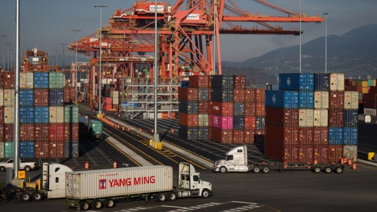 A truck carries a cargo container at the Port of Vancouver Centerm container terminal in Vancouver. (Darryl Dyck/The Canadian Press)
