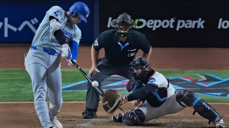 Los Angeles Dodgers' Shohei Ohtani, of Japan, hits a home run scoring Hunter Feduccia during the third inning of a baseball game against the Miami Marlins, Tuesday, Sept. 17, 2024, in Miami. (Wilfredo Lee / AP Photo)
