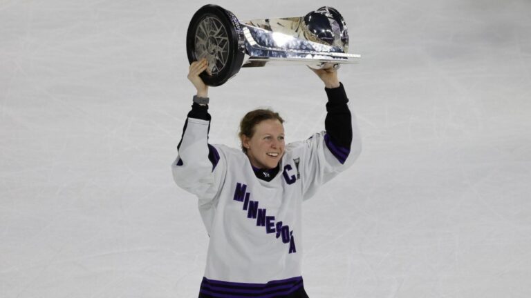 Minnesota captain Kendall Coyne Schofield celebrates with the trophy after beating Boston in Game 5 of the PWHL Walter Cup hockey finals, May 29, 2024, in Lowell, Mass. (AP Photo/Mary Schwalm, File)