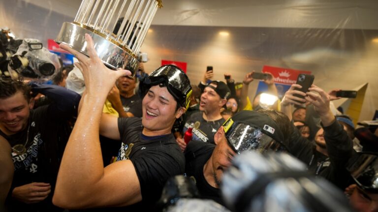 Los Angeles Dodgers' Shohei Ohtani celebrates in the locker room after their win against the New York Yankees in Game 5 to win the baseball World Series, Thursday, Oct. 31, 2024, in New York. (AP Photo/Ashley Landis)