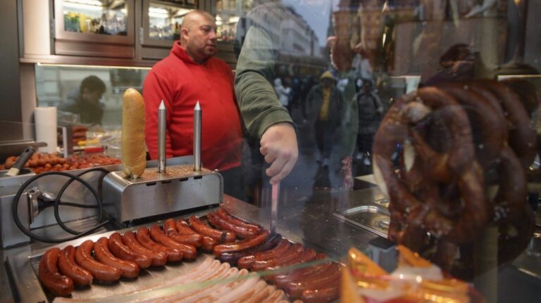Hot sausages get prepared at a traditional sausage stand (Wuerstelstand), which are named as intangible cultural heritage by the Austrian UNESCO Commission, in Vienna, Austria, Thursday, Nov. 28, 2024. (AP Photo/Heinz-Peter Bader)