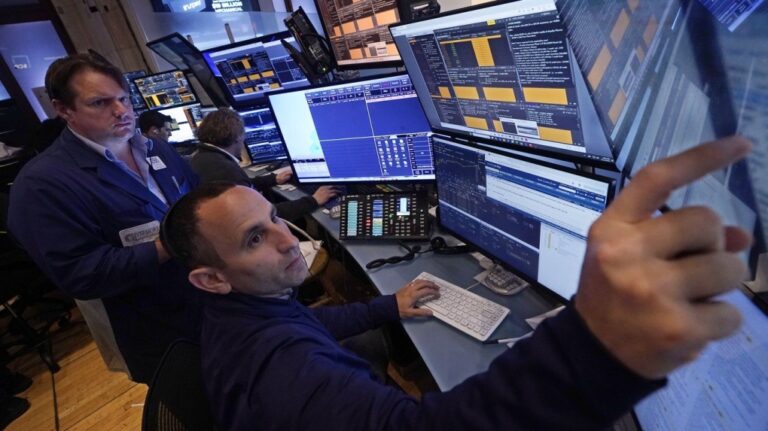 A pair of traders work in their booth on the floor of the New York Stock Exchange, Thursday, Nov. 7, 2024. (Richard Drew / The Associated Press)